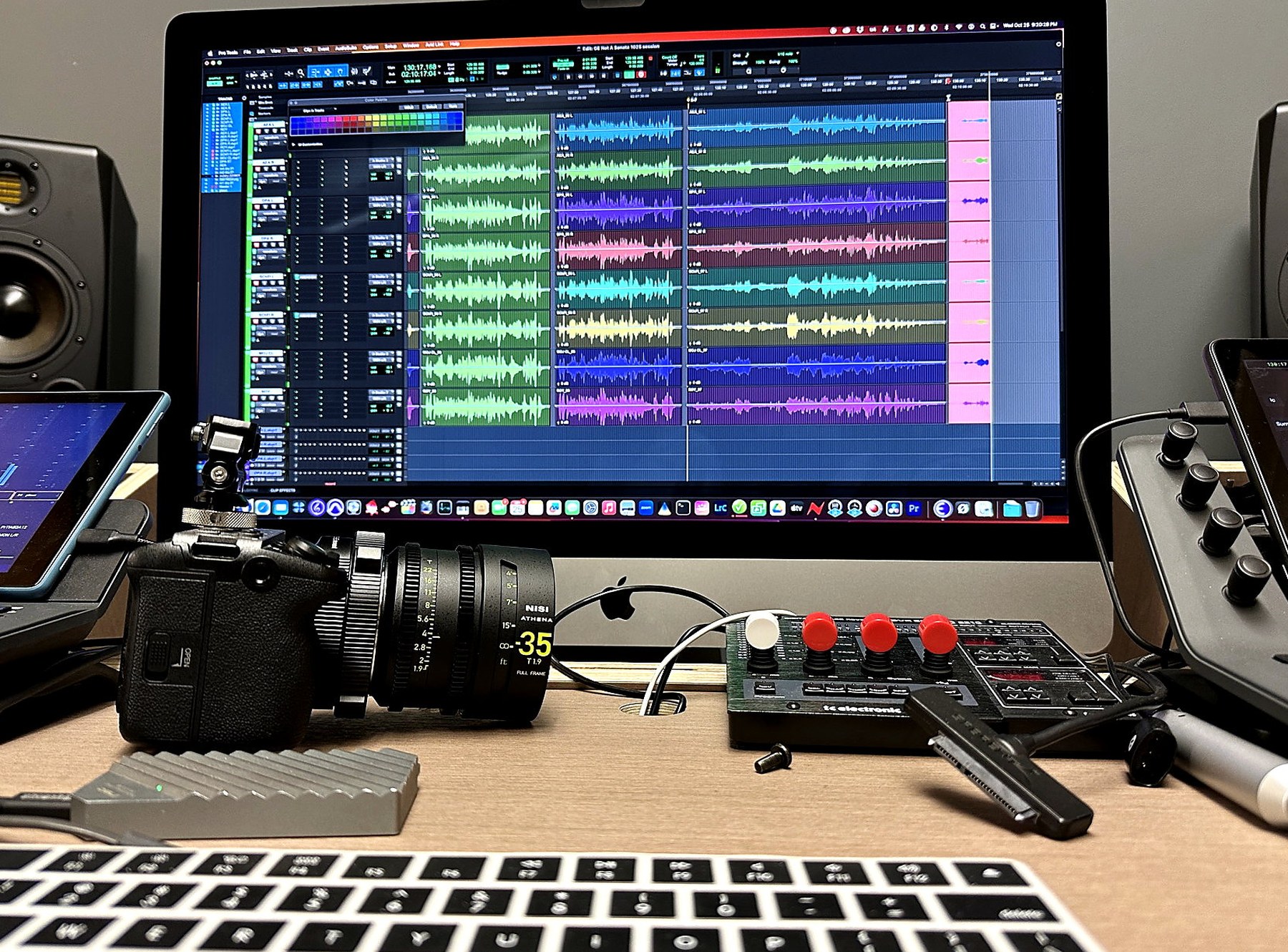 Editing desk with DAW session, camera, and audio tools